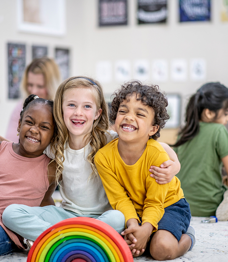 Preschool students smiling and laughing.