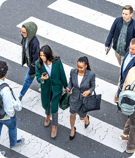 Businesspeople walking across a street