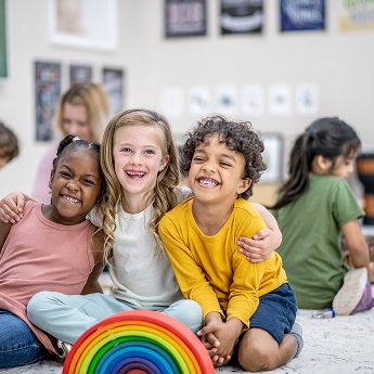 Preschool students smiling and laughing.