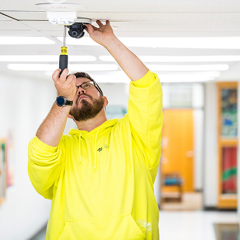 digi employee installing layered school security.
