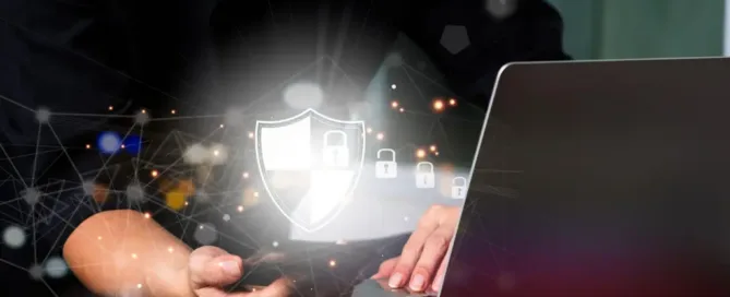 Cybersecurity protection concept showing a digital shield and network security icons over a laptop and a mobile device.