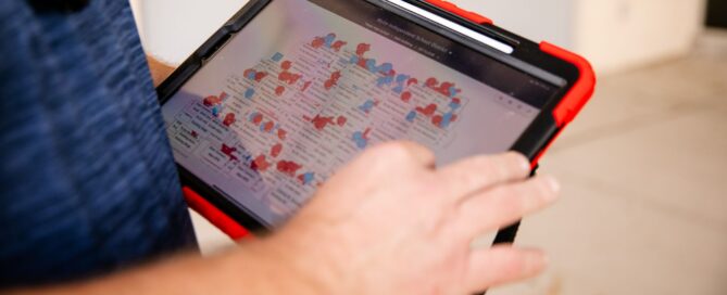 Digi security technician reviewing school access control floor plan on rugged tablet